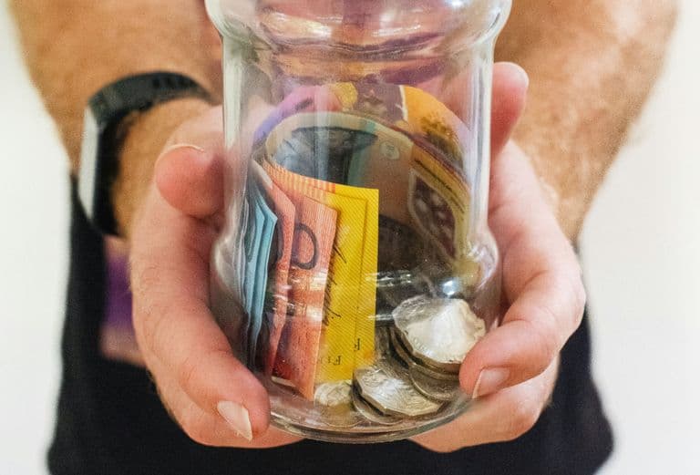 Photo by Melissa Walker Horn on Unsplash Man hold clear glass with Australian money in it - Photo by Melissa Walker Horn on Unsplash