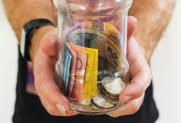 Photo by Melissa Walker Horn on Unsplash Man hold clear glass with Australian money in it - Photo by Melissa Walker Horn on Unsplash